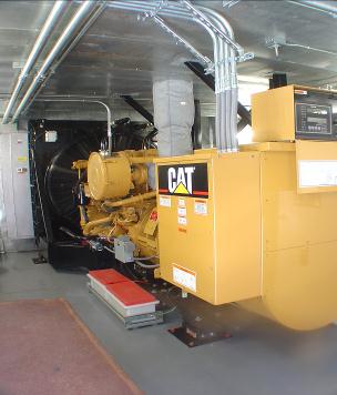 750 kW Caterpillar sound attenuated standby emergency diesel generator module showing left hand skid view.
