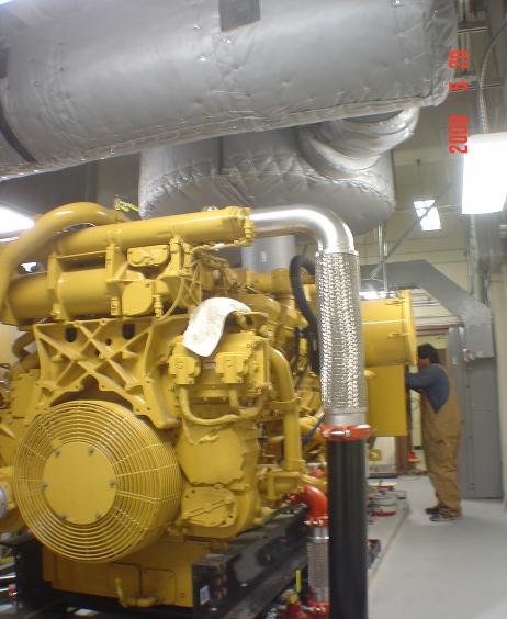 Sound attenuated, 750 Caterpillar diesel generator installation, within a telecommunications building.